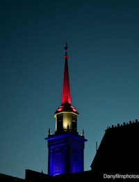 a red, white, and blue building with a steeple