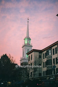 a church with a clock tower in the background