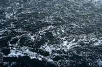 an aerial view of a river with a lot of waves